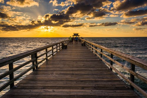 Sunset over the fishing pier in Naples, Florida.